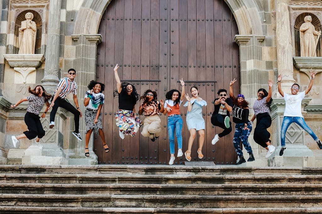 A group of people jumping in the air on steps